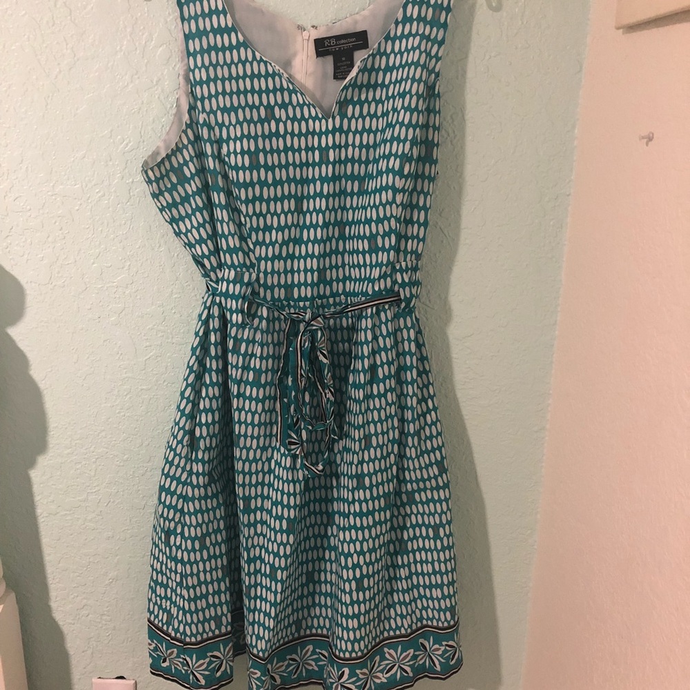 Teal print dress with floral accents and belt